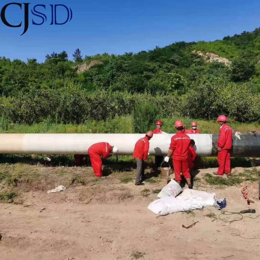 CJSD crew applying epoxy fiberglass protection to a pipeline